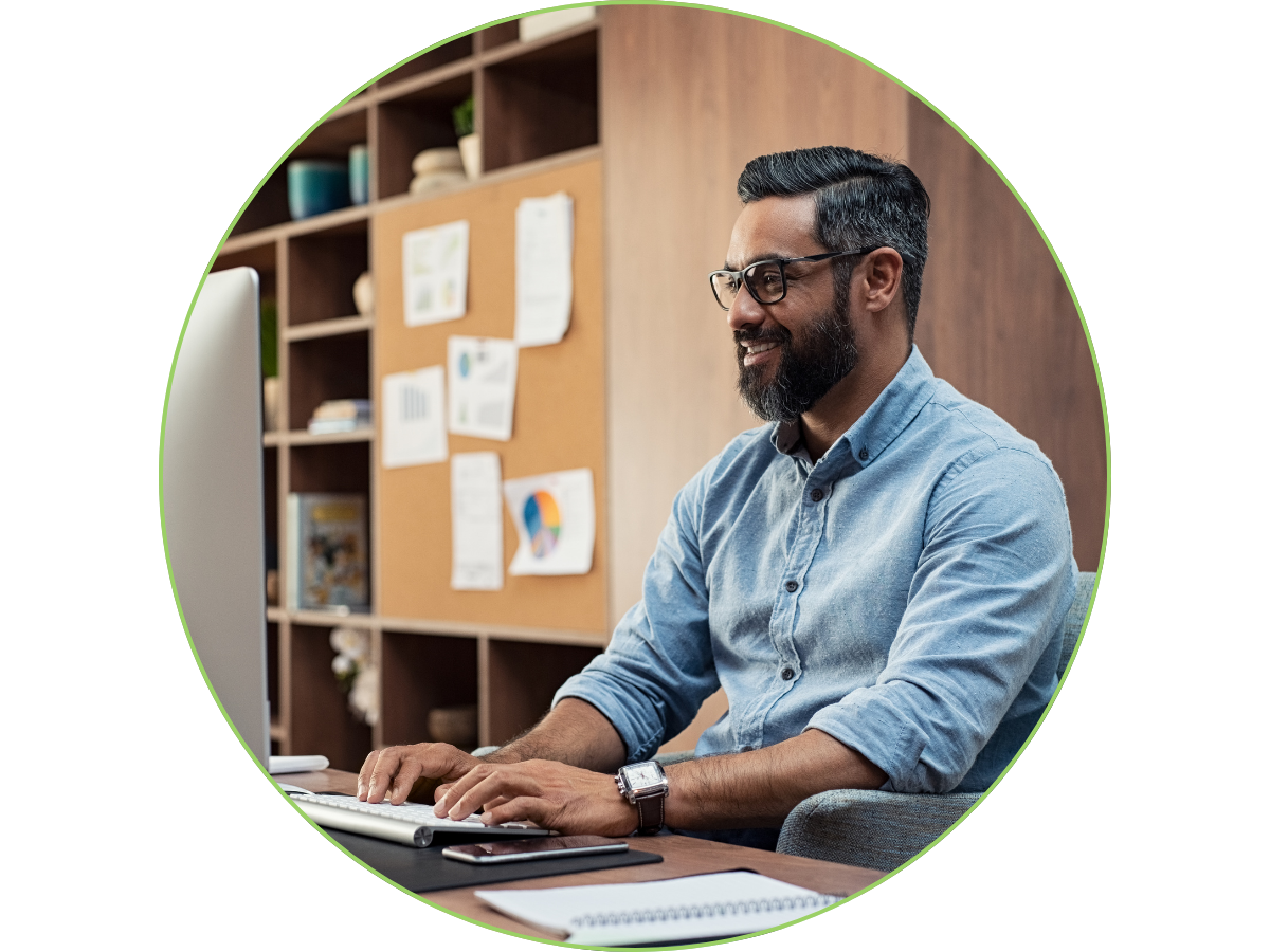 Person working at a desk on a computer
